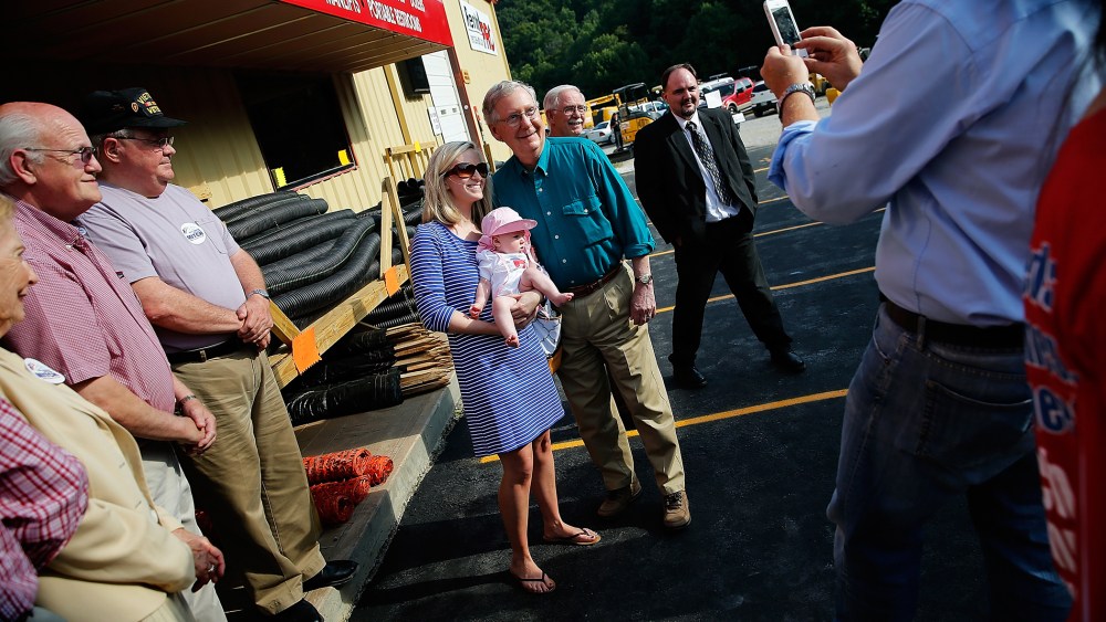 Senate Minority Leader Mitch McConnell (R-KY) poses for a photo while campaigning at a Rental Pro store during a two-day bus tour of eastern Kentucky on Aug. 7, 2014 in Hazard, Ky. (Photo by Win McNamee/Getty)