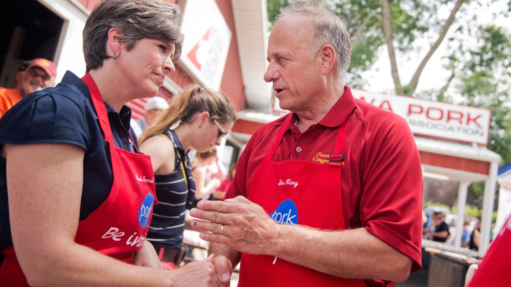Joni Ernst, center, Iowa Republican Senate candidate, and Rep. Steve King, R-Iowa, talk in the Pork Tent at the 2014 Iowa State Fair in Des Moines, Iowa, Aug. 8, 2014.
