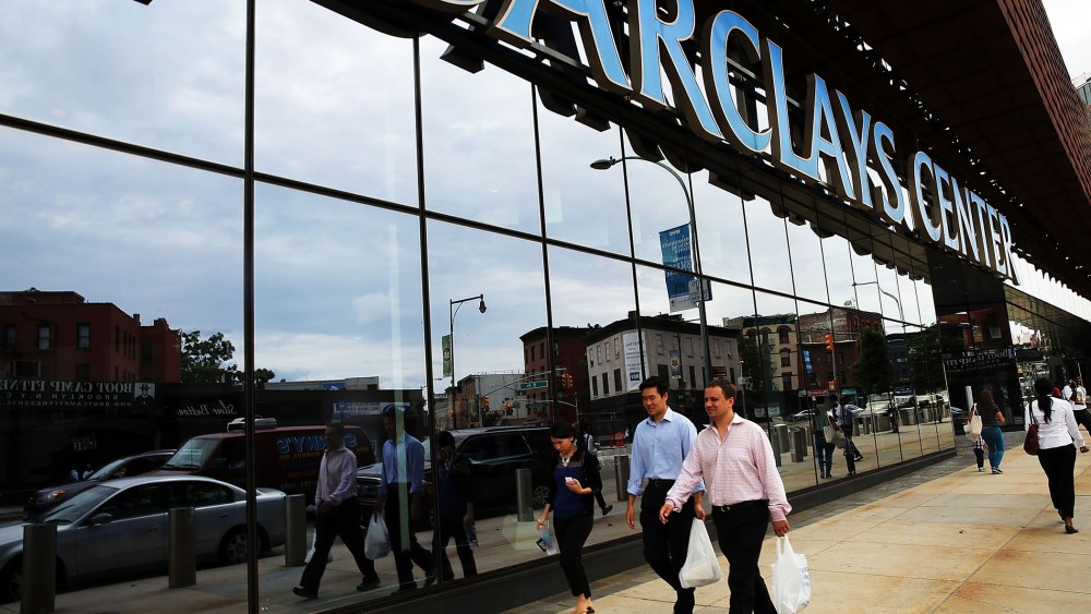 People walk near the Barclays Center on August 12, 2014 in the Brooklyn borough of New York City.