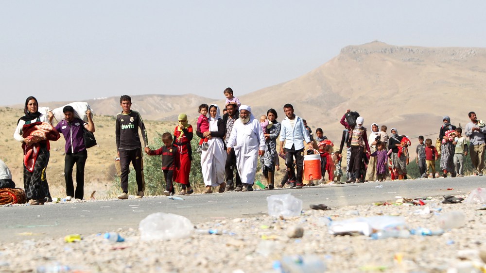 Displaced Iraqi families from the Yazidi community cross the Iraqi-Syrian border at the Fishkhabur crossing, in northern Iraq, on August 13, 2014.