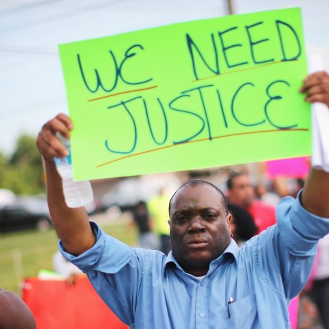 Demonstrators protest the shooting death of teenager Michael Brown on August 14, 2014 in Ferguson, Missouri.