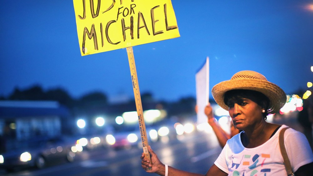 Gwen Stewart joins other demonstrators along West Florissant Avenue to protest the shooting death of Michael Brown on August 14, 2014 in Ferguson, Missouri.
