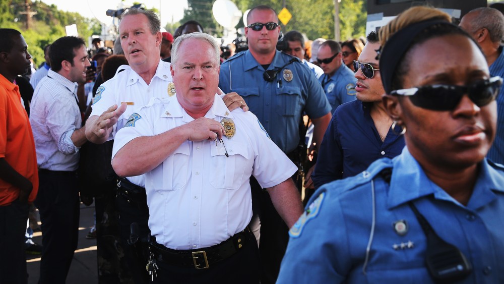Ferguson Police Chief Thomas Jackson leaves the parking lot of a gas station, which was burned during rioting, after he announced the name of the Ferguson police officer responsible for the August 9, shooting death of teenager Michael Brown on August 15,
