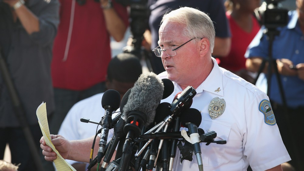 Standing in the parking lot of a gas station which was burned during rioting, Ferguson Police Chief Thomas Jackson announces the name of the Ferguson police officer responsible for the August 9, shooting death of teenager Michael Brown on August 15, 2014
