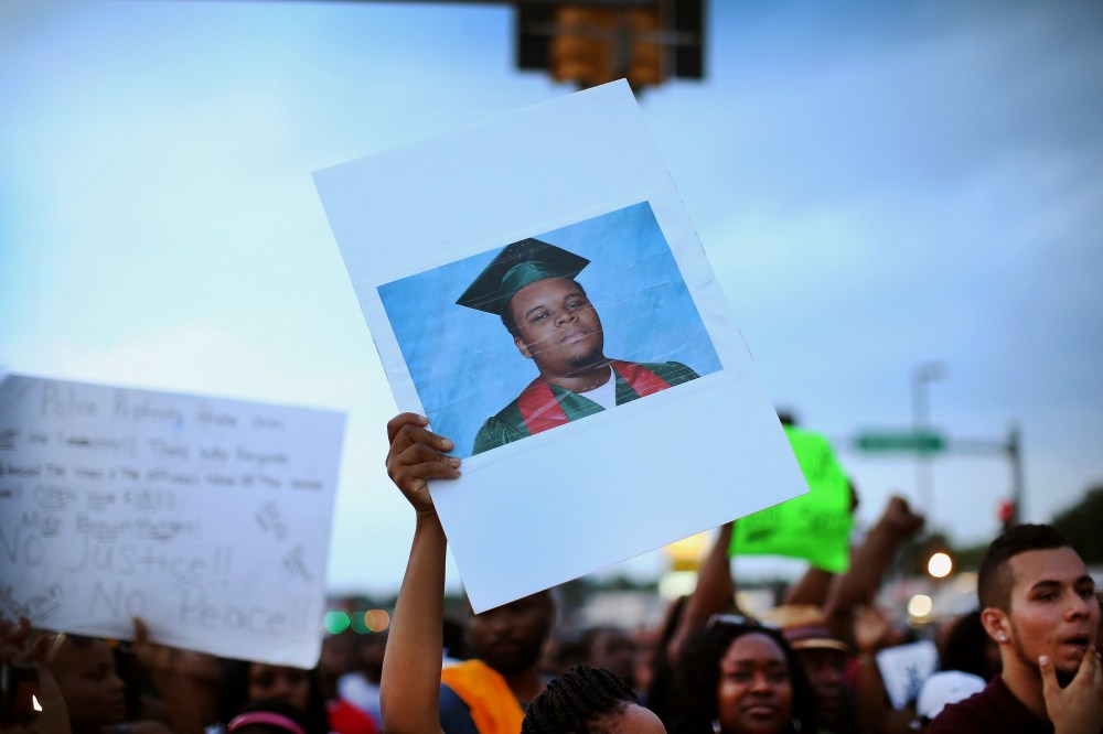 A demonstrator carries a picture of Michael Brown during a protest along Florissant Avenue on Aug. 16, 2014 in Ferguson, Mo.