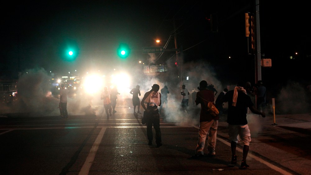 Tear gas and smoke wafts around the site of a protest of the death of Michael Brown Aug. 17, 2014 in Ferguson, Missouri.