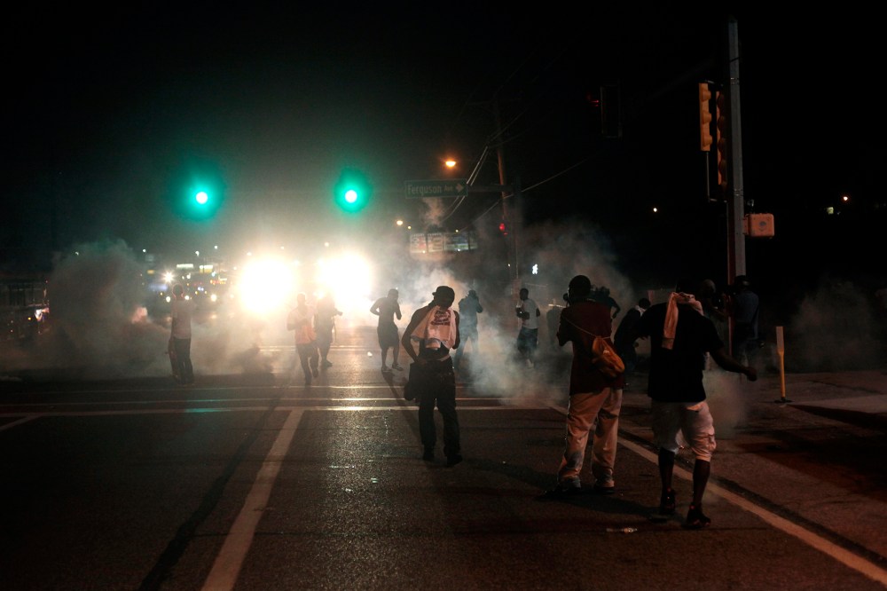 Tear gas and smoke wafts around the site of a protest of the death of Michael Brown Aug. 17, 2014 in Ferguson, Missouri.