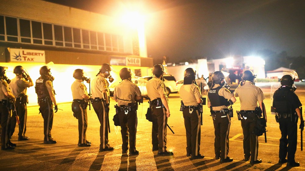 Police advance on demonstrators protesting the killing of teenager Michael Brown on August 17, 2014 in Ferguson, Missouri.