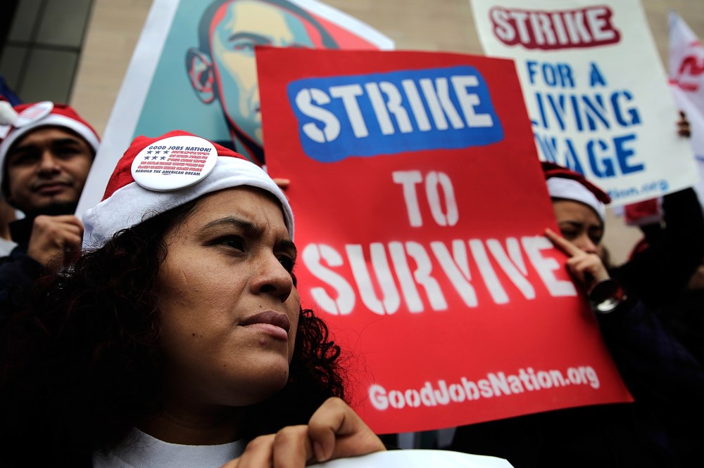 Low wage workers join with supporters of an increase in the minimum wage during a protest outside the Air and Space Museum, Dec. 5, 2013 in Washington, D.C.