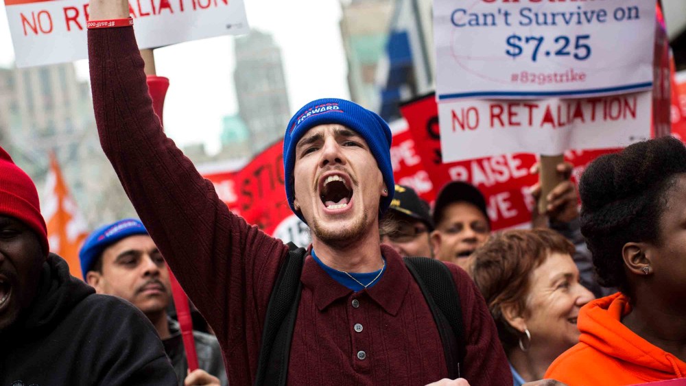 Protesters rally outside of a Wendy's in support of raising fast food wages in Brooklyn, New York, Dec. 5, 2013.