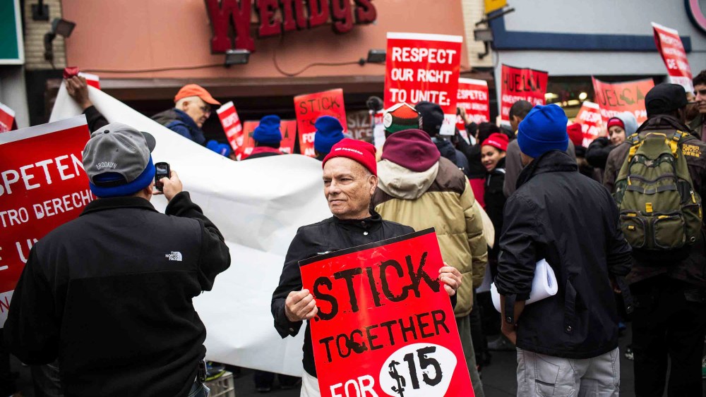 Protesters rally outside of a Wendy's in support of raising fast food wages in Brooklyn, Dec. 5, 2013.