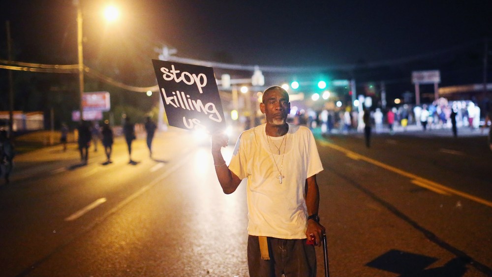 Frederick Scott protests the killing of teenager Michael Brown on Aug. 18, 2014 in Ferguson, Mo.