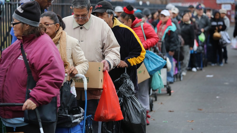 Brooklyn residents receive free food as part of a Bowery Mission outreach program on December 5, 2013 in the Brooklyn borough of New York City.