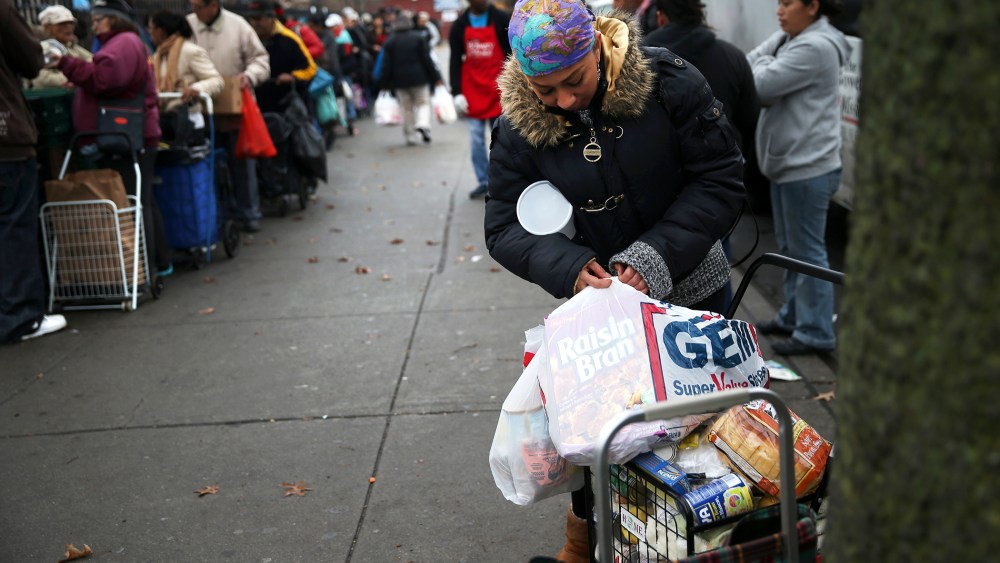 Brooklyn residents receive free food as part of a Bowery Mission outreach program on December 5, 2013.