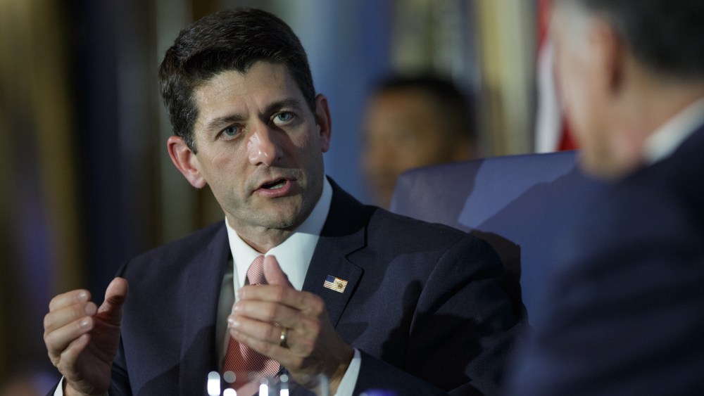 U.S. Rep. Paul Ryan (R-WI) answers a question while he is interviewed by former Republican presidential candidate Mitt Romney in Chicago, Aug. 21, 2014.