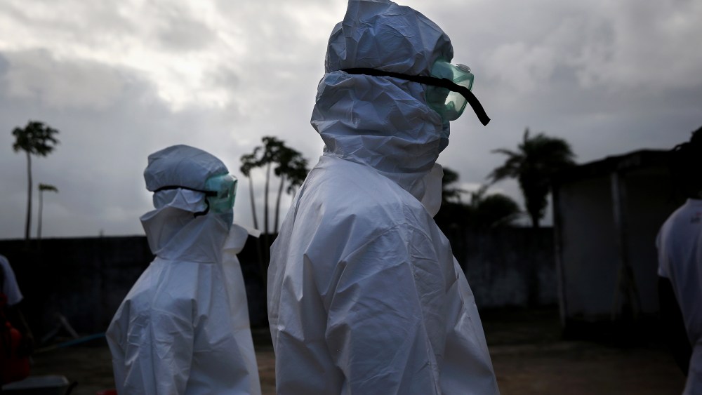 A burial team from the Liberian Ministry of Health prepares to unload the bodies of Ebola victims onto a funeral pyre at a crematorium on Aug. 22, 2014 in Marshall, Liberia.