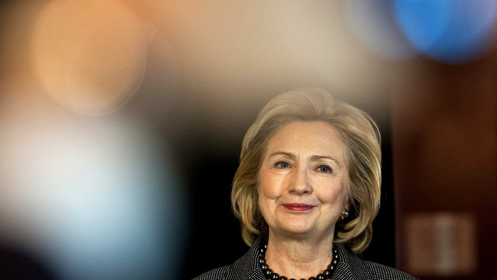 Former US Secretary of State Hillary Clinton listens to a speaker on Capitol Hill in Washington, D.C., on Dec. 6, 2013. (Photo by Nicholas Kamm/AFP/Getty)