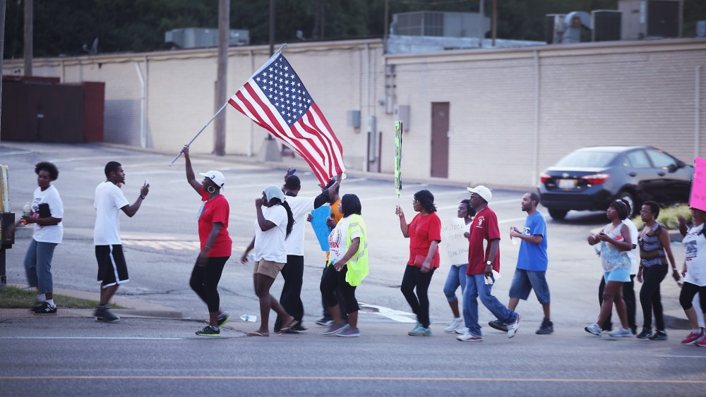Demonstrators protest the death of Michael Brown on August 22, 2014 in Ferguson, Missouri.