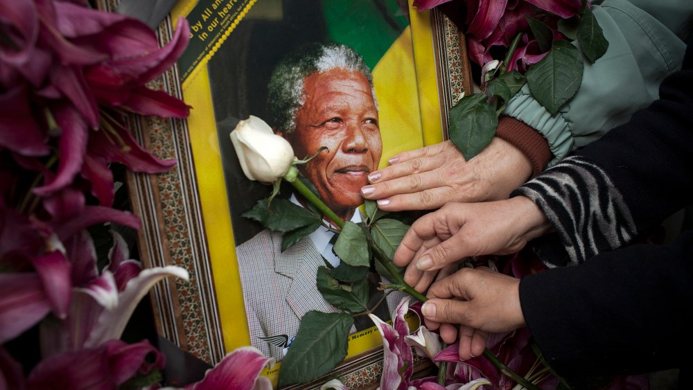 Mourners gathered in front of the South African embassy to pay their respects to the memory of Nelson Mandela on December 7, 2013 in Tehran, Iran.