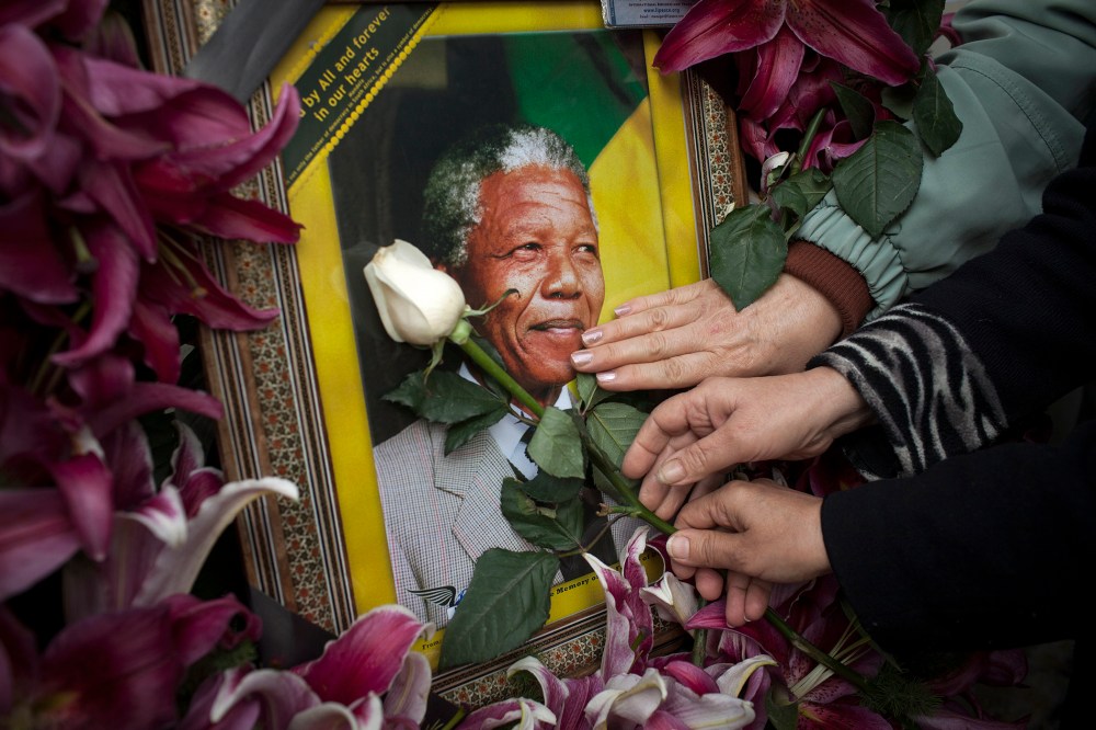 Mourners gathered in front of the South African embassy to pay their respects to the memory of Nelson Mandela on December 7, 2013 in Tehran, Iran.