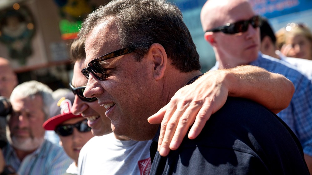 New Jersey Governor Chris Christie takes a photo with a fan while touring the boardwalk on August 29, 2014 in Point Pleasant, New Jersey.
