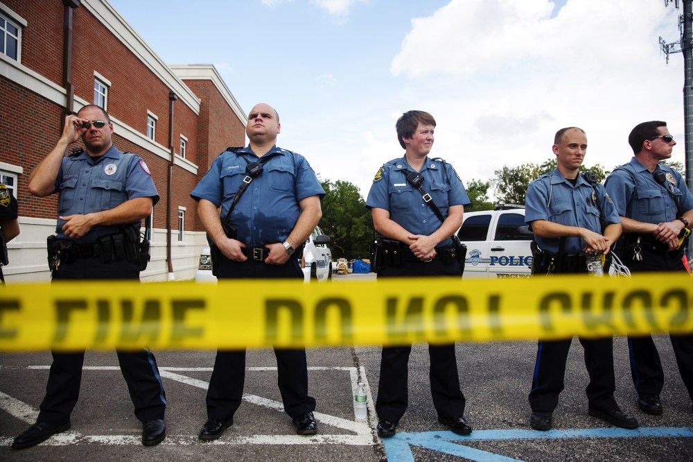 Police stand guard during a rally for Michael Brown outside the Ferguson Police Department August 30, 2014 in Ferguson, Missouri.