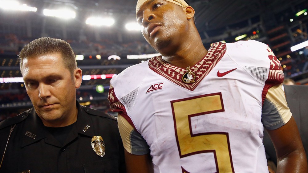 Jameis Winston of the Florida State Seminoles walks off the field after a game at AT&T Stadium on Aug. 30, 2014 in Arlington, Texas.  Photo by Tom Pennington/Getty