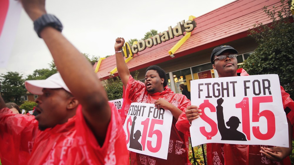 Demonstrators protest for an increase in wages for fast food and home care workers during the morning rush hour on Sept. 4, 2014 in Chicago, Illinois. (Photo by Scott Olson/Getty)