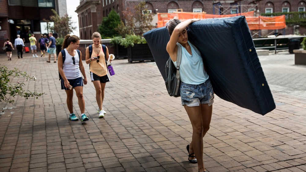 Emma Sulkowicz, a senior visual arts student at Columbia University, carries a mattress in protest of the university's lack of action after she reported being raped during her sophomore year on Sep. 5, 2014 in New York City. (Photo by Andrew Burton/Getty)
