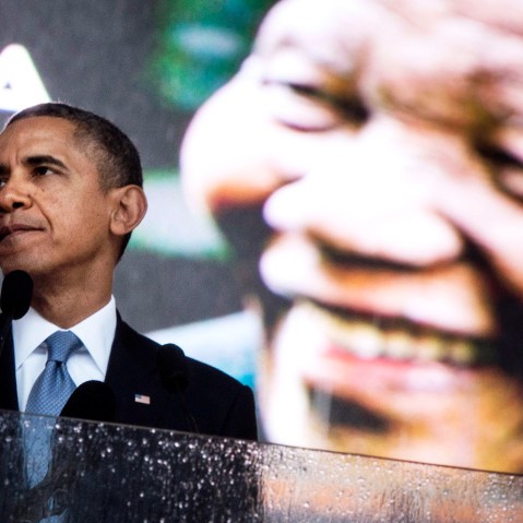 US President Barack Obama pauses while speaking during the memorial service for Nelson Mandela in Johannesburg, Dec. 10, 2013.