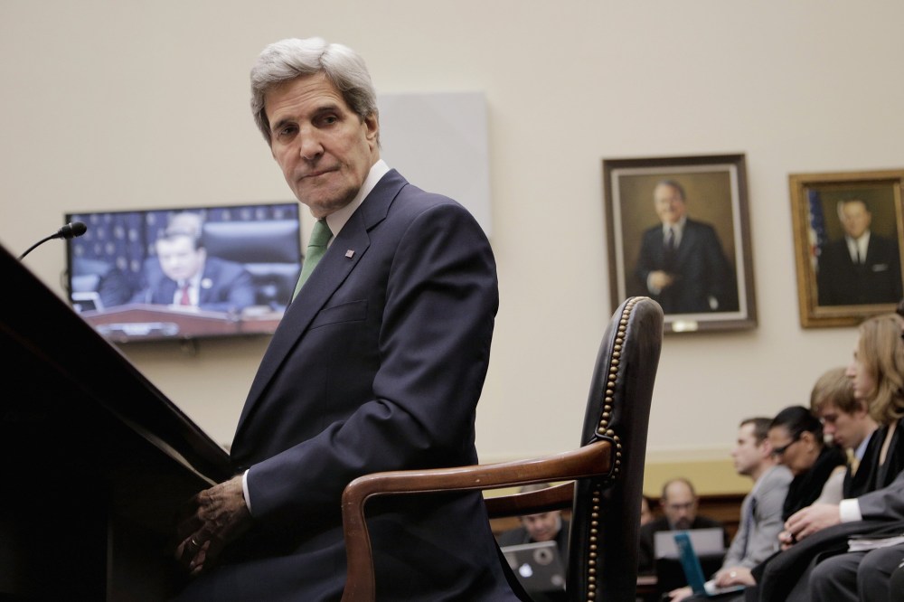 Secretary of State John Kerry waits to testify before the House Foreign Affairs Committee on December 10, 2013 in Washington, D.C.