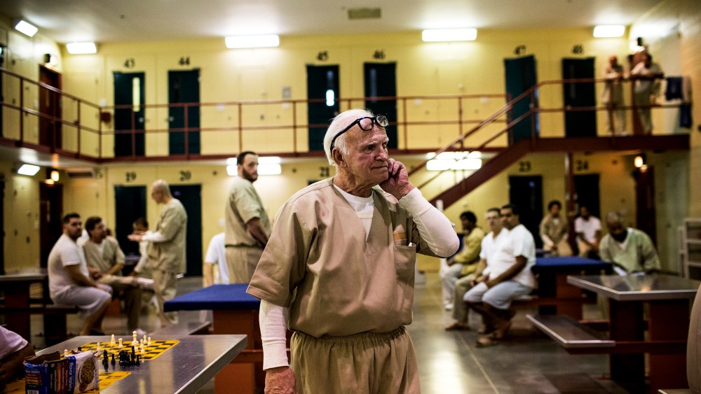 A prisoner at Rhode Island's John J. Moran Medium Security Prison walks through his cell block, Dec. 10, 2013.