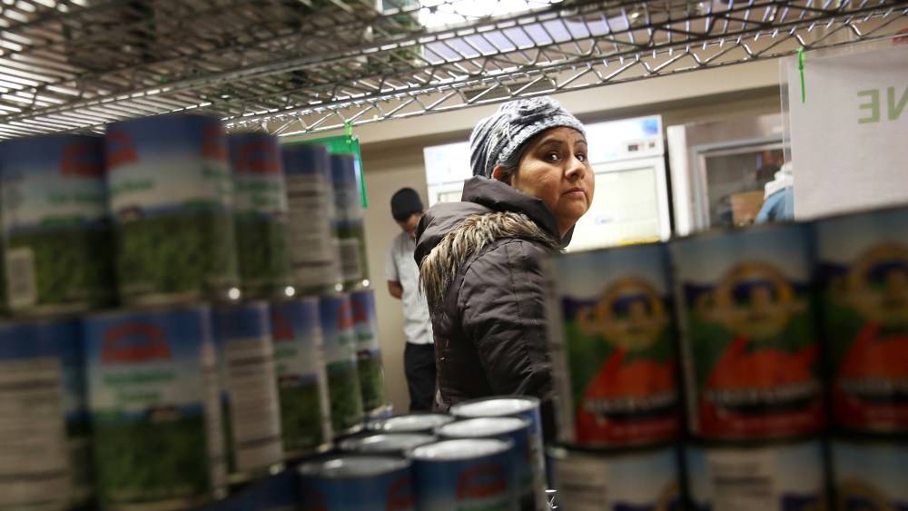 A Harlem resident chooses free groceries at the Food Bank For New York City, Dec. 11, 2013.