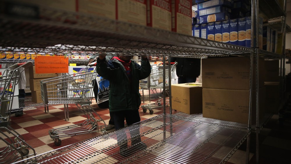 A child accompanies his grandmother choosing free groceries at a food pantry run by the Food Bank For New York City on Dec. 11, 2013 in New York City. (John Moore/Getty)