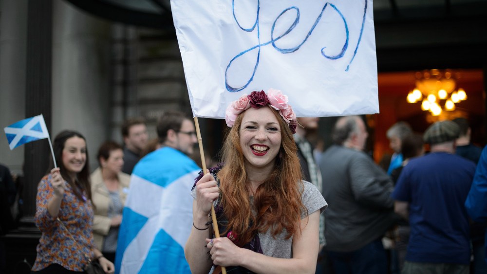 "Yes" campaign supporter waves a flag outside Usher Hall ahead of the "A Night for Scotland" concert in Edinburgh, Scotland on Sept. 14, 2014.