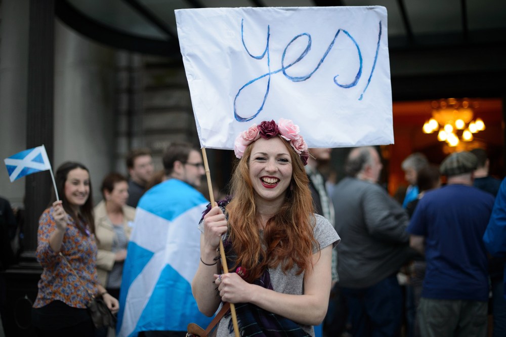 "Yes" campaign supporter waves a flag outside Usher Hall ahead of the "A Night for Scotland" concert in Edinburgh, Scotland on Sept. 14, 2014.