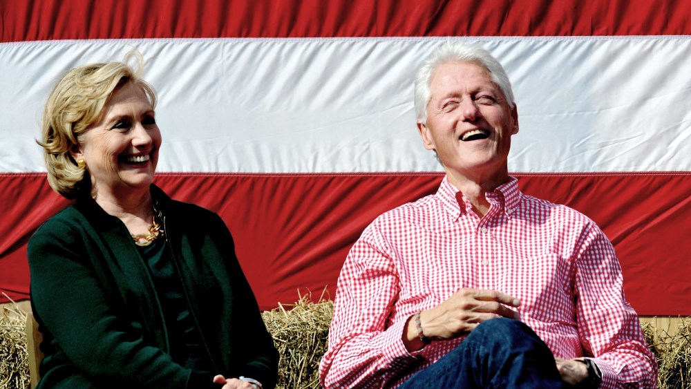 Former President Bill Clinton and his wife former Secretary of State Hillary Rodham Clinton laugh during during the 37th Harkin Steak Fry, Sept. 14, 2014 in Indianola, Iowa. (Photo by Steve Pope/Getty)