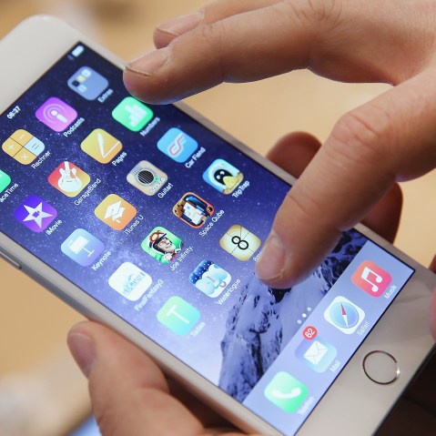 A shopper tries out the new Apple iPhone 6 at the Apple Store on the first day of sales of the new phone in Germany on September 19, 2014.