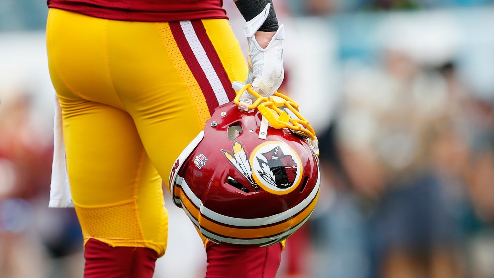 A Washington Redskins helmet is carried by a player on Sept. 21, 2014 in Philadelphia, Pa. (Photo by Rich Schultz/Getty)