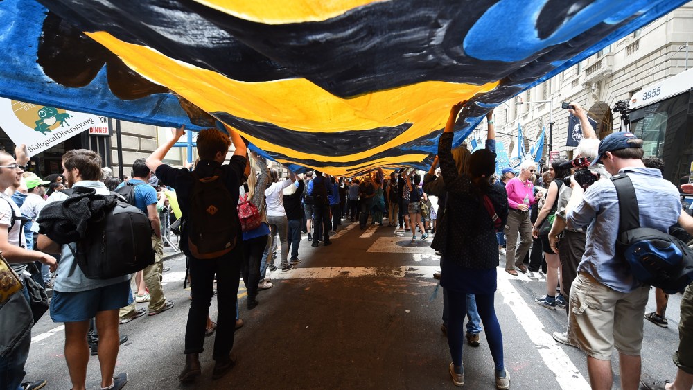 Protestors make their way up Broadway as they take part in the "Flood Wall Street" demonstrations on Sept. 22, 2014, preceding the United Nations's "Climate Summit 2014: Catalyzing Action" in New York, N.Y. (Photo by Timothy A. Clary/AFP/Getty)
