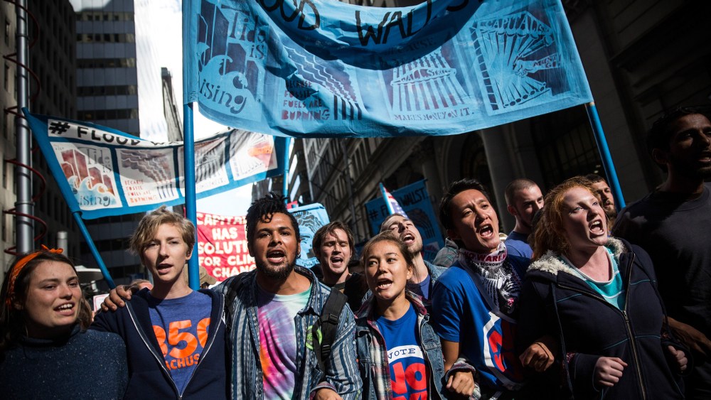 Protesters demanding economic and political changes to curb the effects of global warming march toward the New York Stock Exchange on September 22, 2014 in New York City.