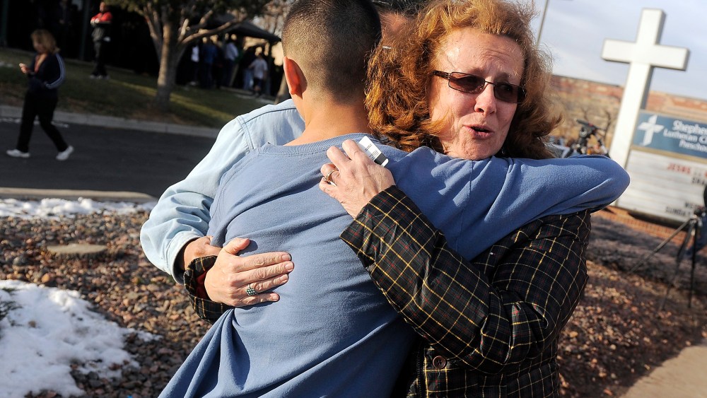JoAnne Allen, right, hugs her son Alex Allen, 17, after a school shooting on December 13, 2013 at Arapahoe High School in Centennial, Colorado.