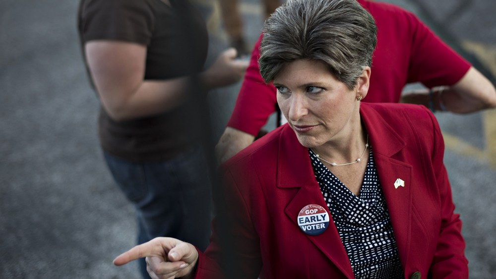 Republican Joni Ernst, running for the U.S. Senate in Iowa, gestures toward a supporter outside the Scott County GOP headquarters during a campaign stop in Davenport, Iowa, on Sept. 25, 2014.