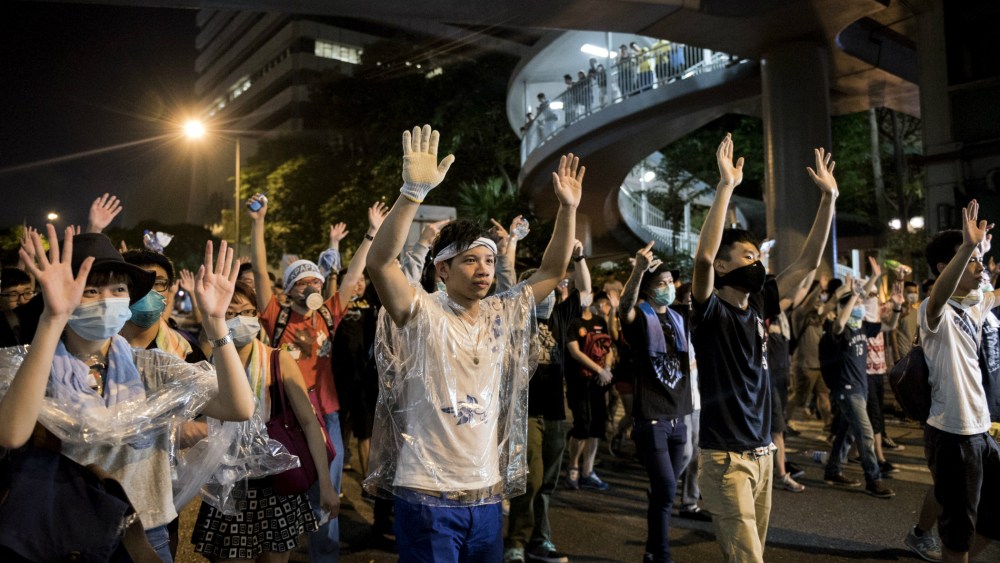 Pro-democracy protesters put their hands up in the air in front of the police in Hong Kong on Sept. 28, 2014.