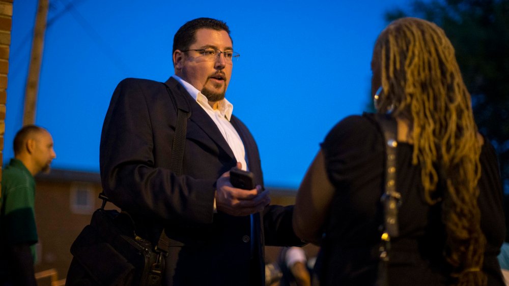 Ferguson Mayor James Knowles (L) speaks with resident Juanita Stone after a town hall meeting with local government officials and residents on Sept. 30, 2014 at Our Lady of Guadalupe in Ferguson, Mo. (Whitney Curtis/Getty)