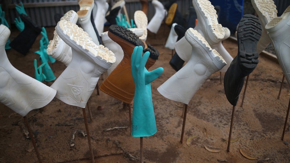 Sanitized gloves and boots hang to dry as a burial team collects Ebola victims from a Ministry of Health treatment center for cremation on October 2, 2014 in Monrovia, Liberia.