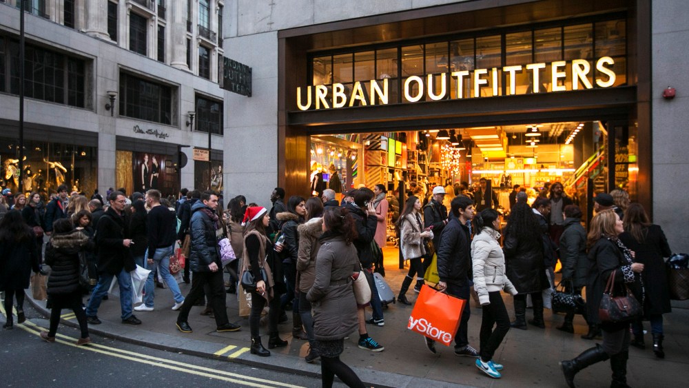 Shoppers walk outside an Urban Outfitters store, Dec. 2013.