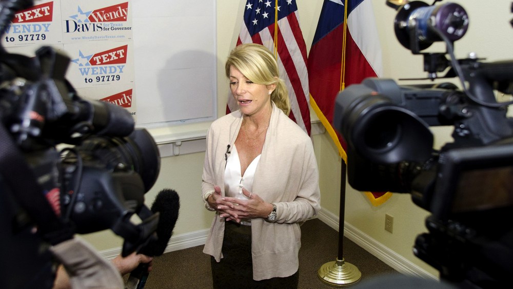 Texas Democrat State Senator Wendy Davis answers media questions during the opening of her gubernatorial campaign headquarters in Fort Worth, Texas, Dec. 14, 2013.