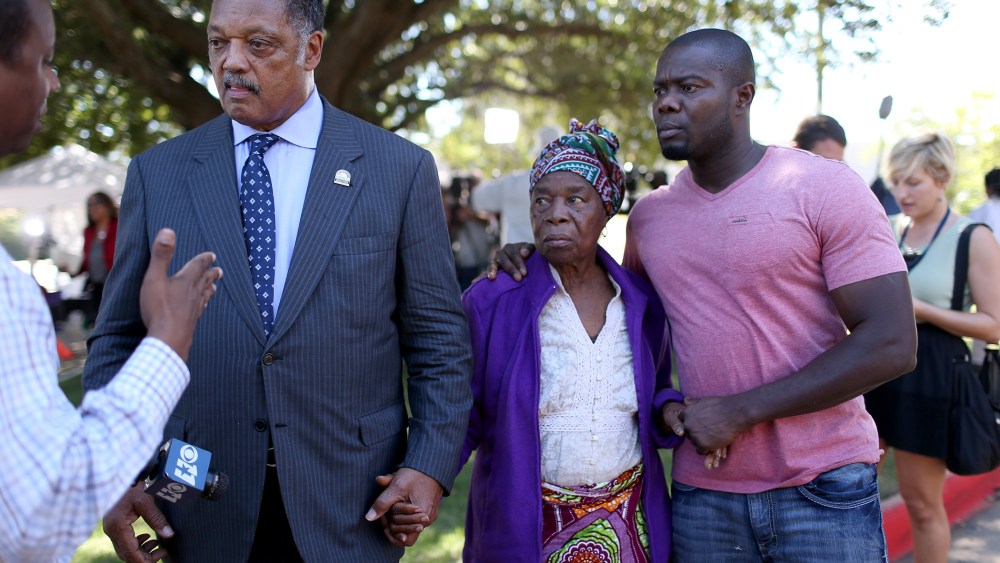 Rev. Jesse Jackson (L) stands with Nowai korkoyah (C) the mother of Ebola patient Thomas Eric Duncan, as well as his nephew, Josephus Weeks, as they speak to the media at the Texas Health Presbyterian hospital on October 7, 2014 in Dallas, Texas.