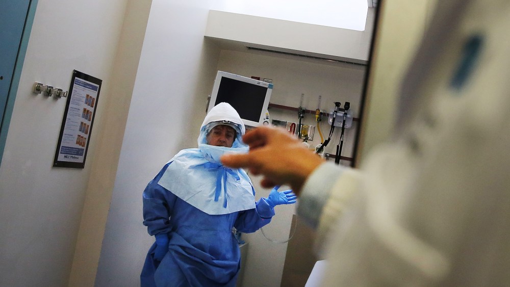Members of Bellevue Hospital staff wear protective clothing as they demonstrate how they would receive a suspected Ebola patient on October 8, 2014 in New York City.